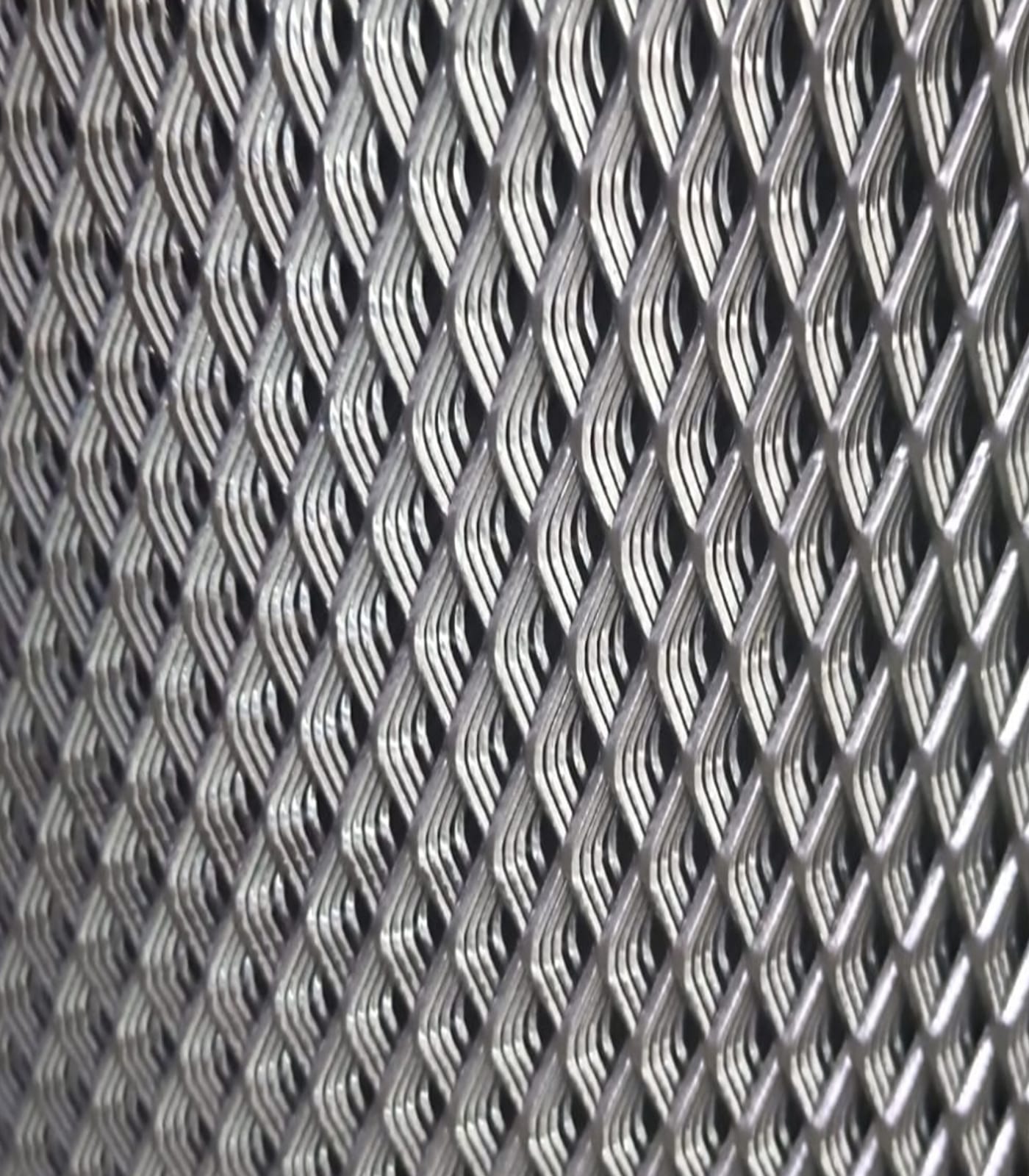 Macro close-up of HI-TECH expanded metal mesh, showing the diamond weave pattern